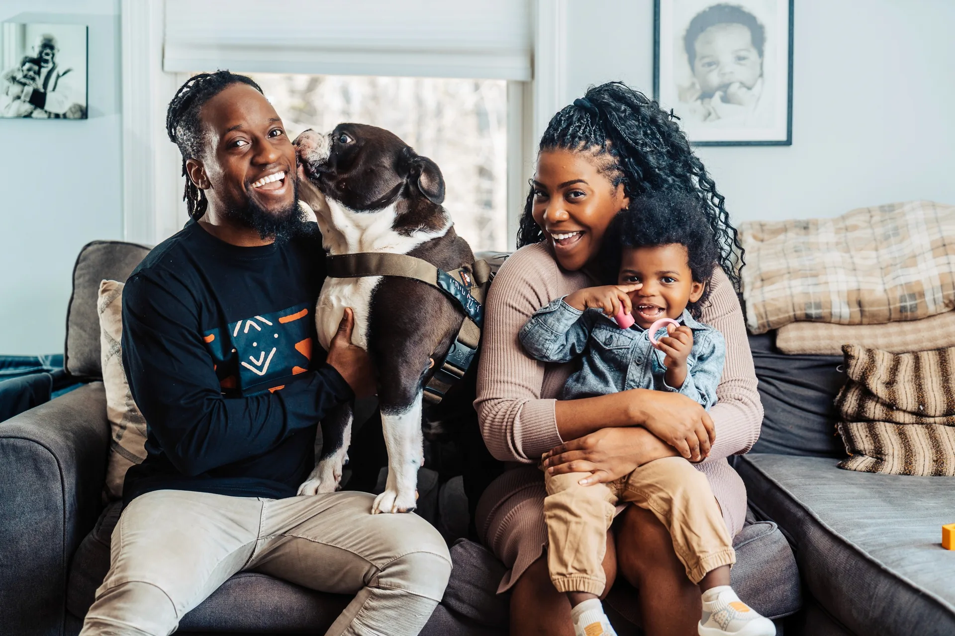 Muyinza with his family and their dog on the sofa