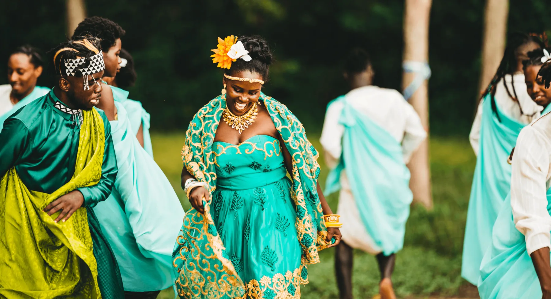 A bride smiling among family and friends during a wedding celebration