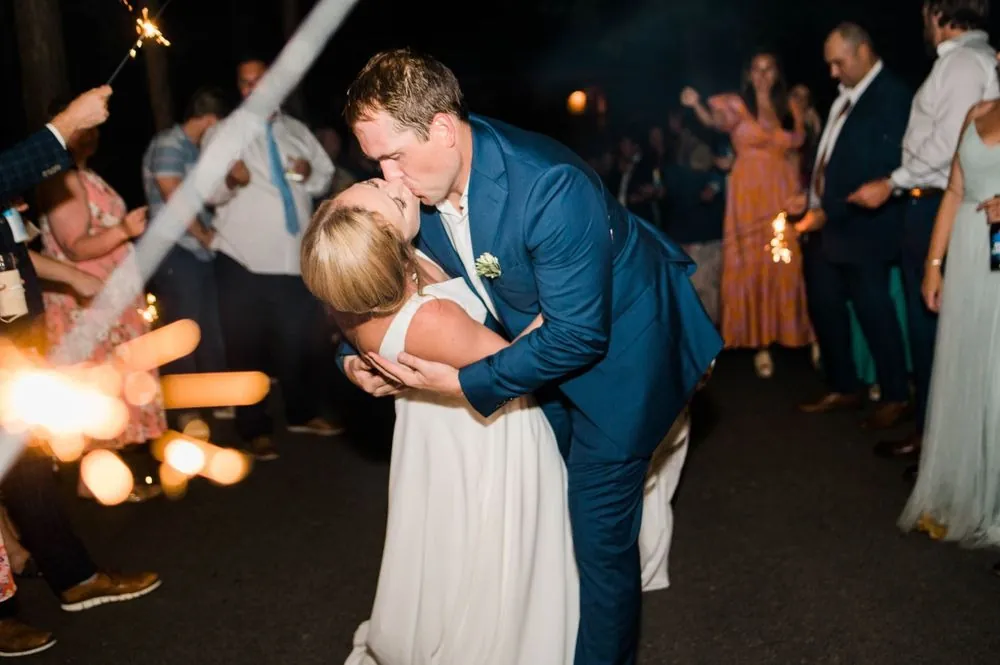 Robert dips Alexandra for a kiss in a tunnel of sparklers after dark
