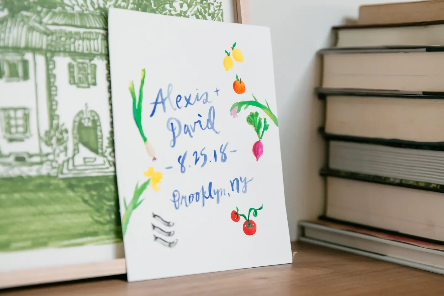 Hand-painted wedding sign with the date, surrounded by watercolor lemons, radishes, and tomatoes