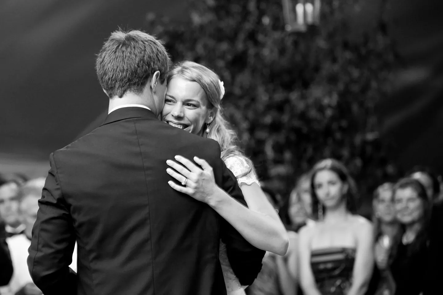 Alli and Dave hold each other close on the dance floor, in black and white