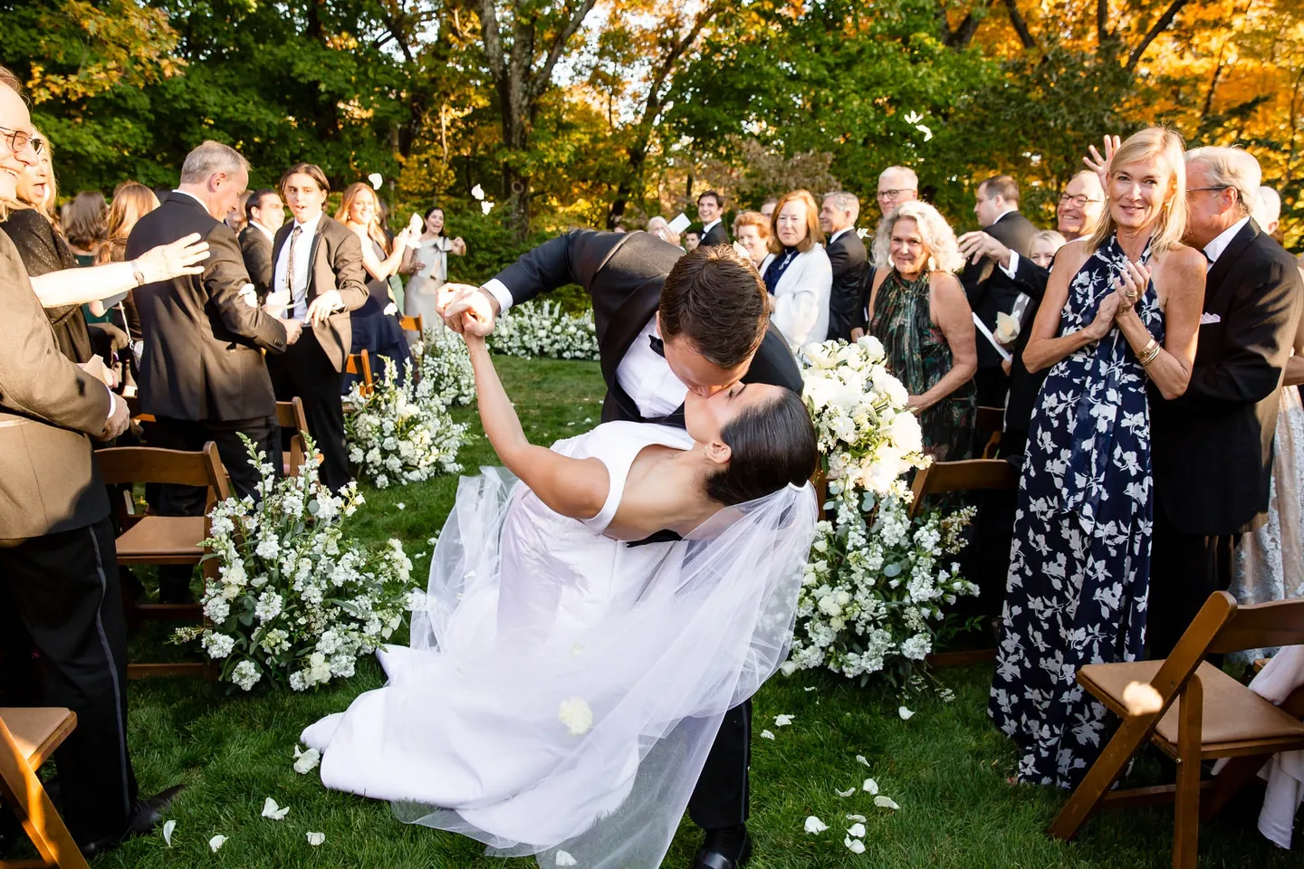 Matt dips Angie low in the aisle as guests laugh and applaud around them