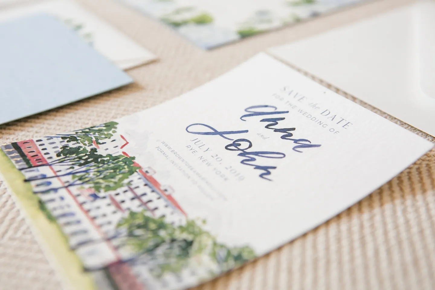 A watercolor save-the-date with the clubhouse illustrated beside hand-lettered names