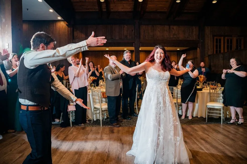 Ashley and Brian throw their arms wide for the grand entrance as guests cheer