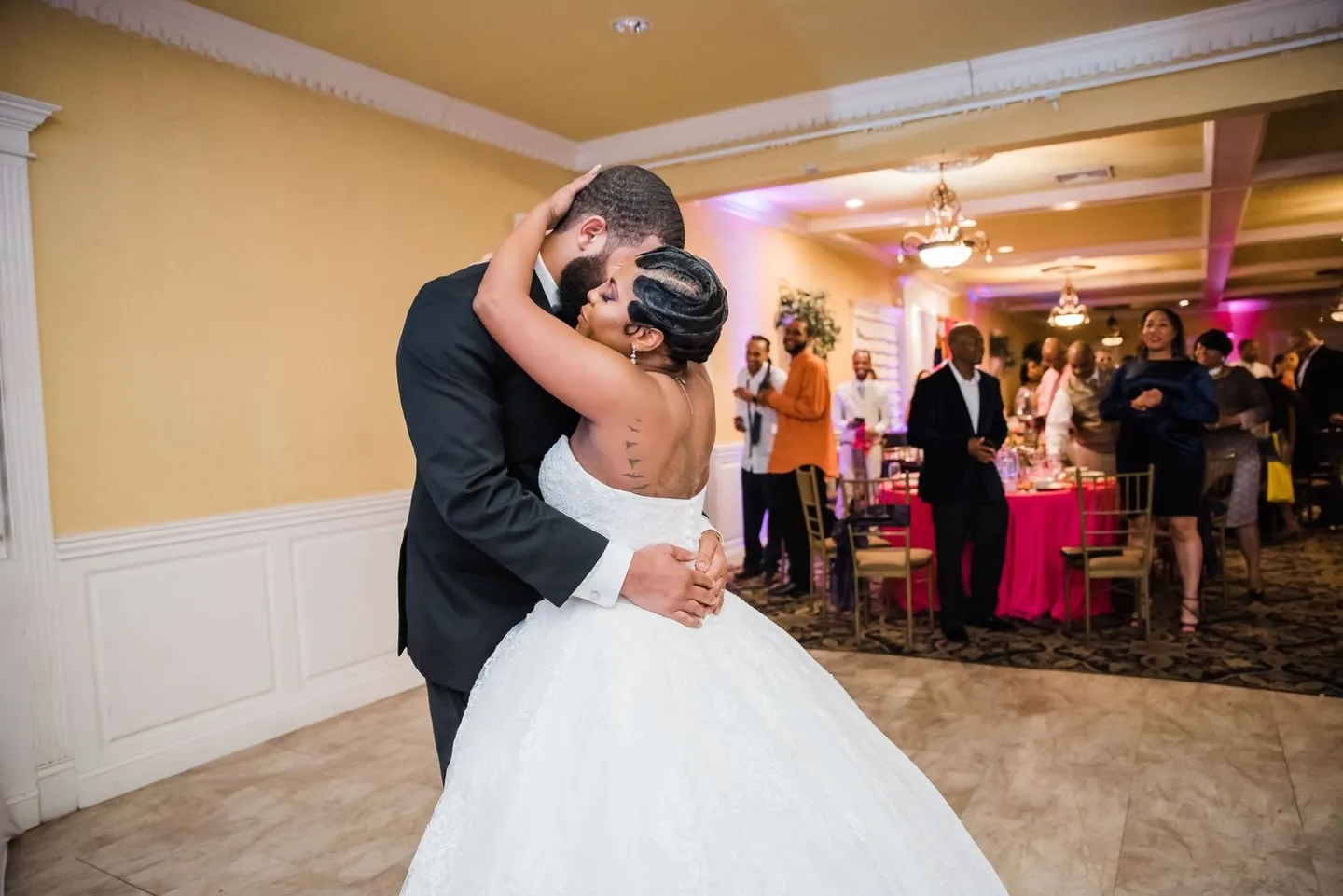 Darren wraps Ashley in a hug on the reception floor as guests look on