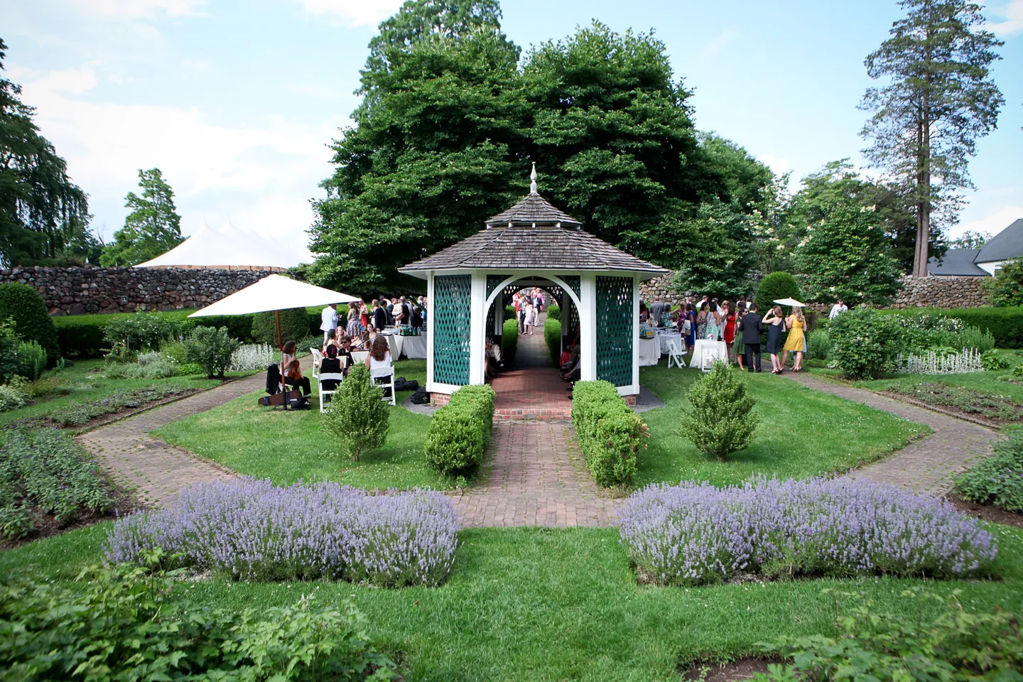 A sunken garden with lavender borders leads to a small green-roofed summerhouse