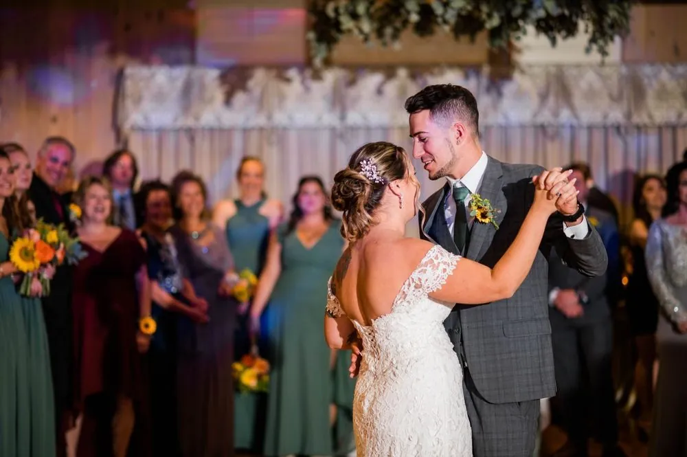 Caroline and Zachary share their first dance as guests watch around them