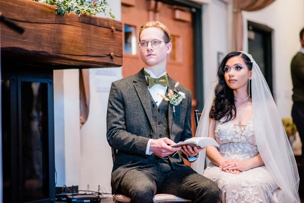 Colin holds a small book beside Victoria during the fireside ceremony