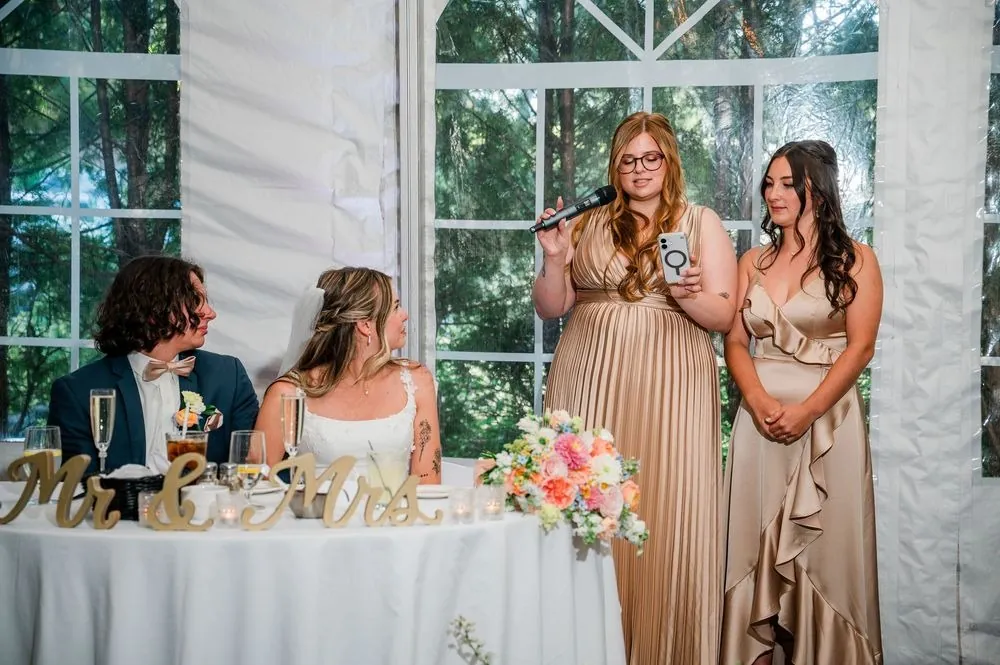 Bridesmaids give a toast beside the Mr and Mrs sweetheart table
