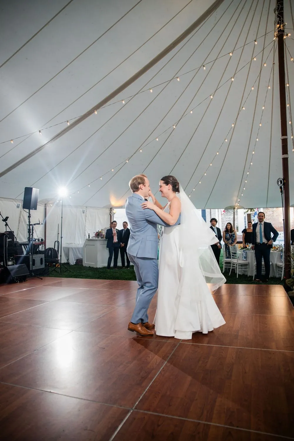 First dance on a polished wood floor under the peaked sailcloth tent