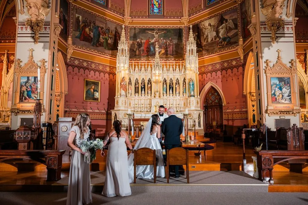 Wide view of the ornate church altar with painted arches during the vows