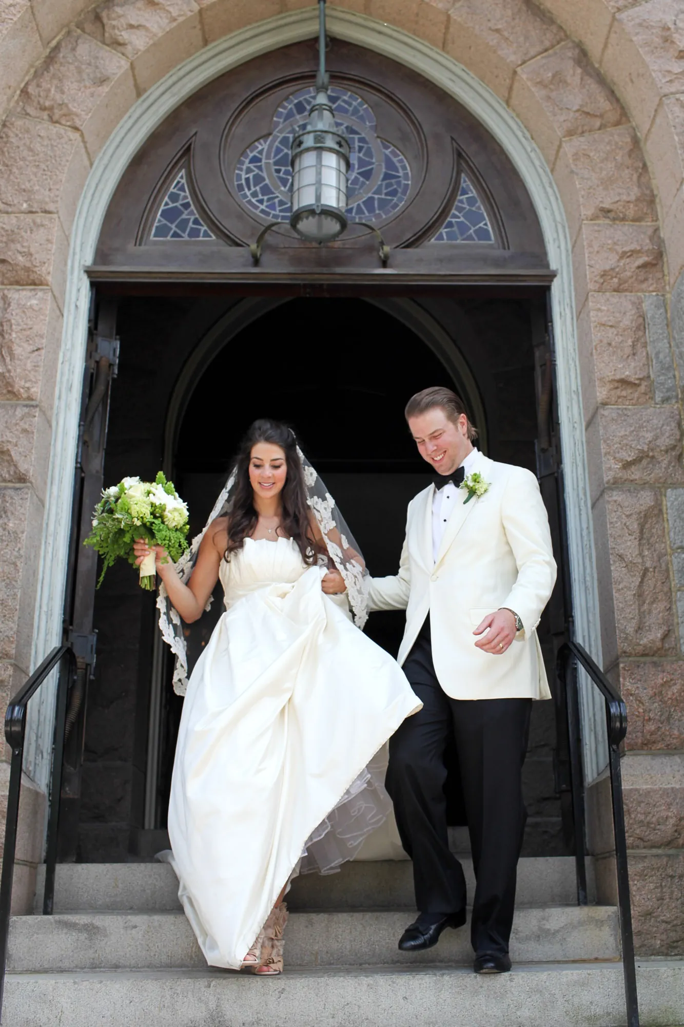 Kaitlin and Matthew pause in the arched stone doorway of the church