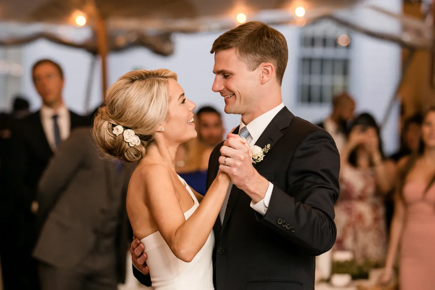 Kristen and Charlie share their first dance under the tent as guests watch