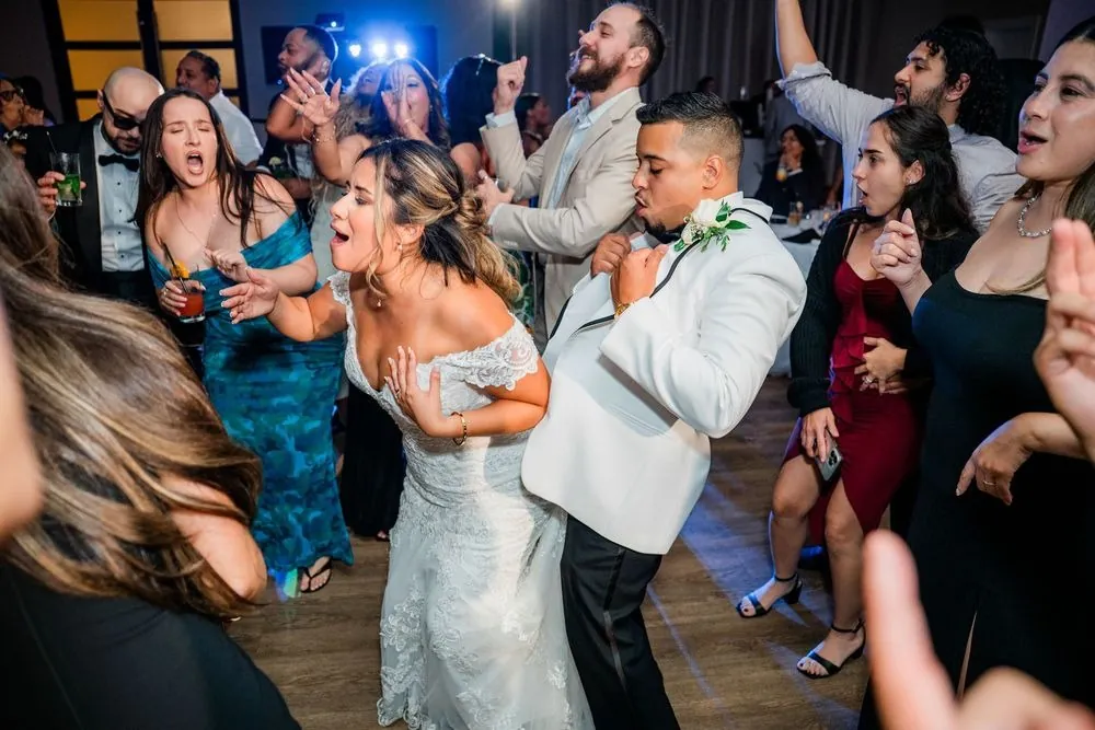 Leslie and Miguel dance in the middle of a crowded, shouting dance floor