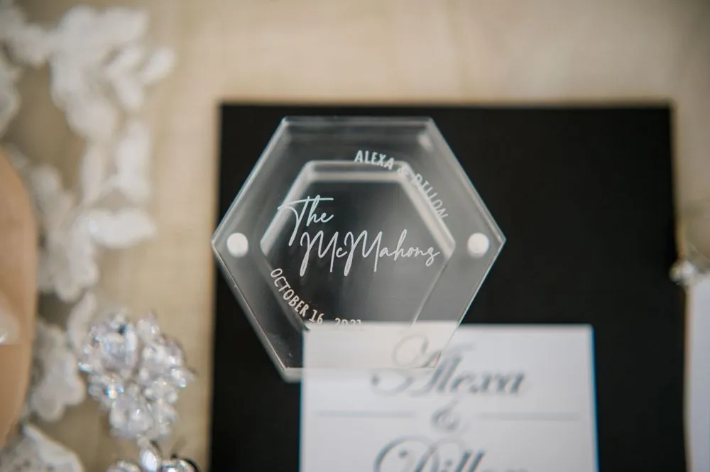An etched acrylic sign with the couple's new last name and wedding date