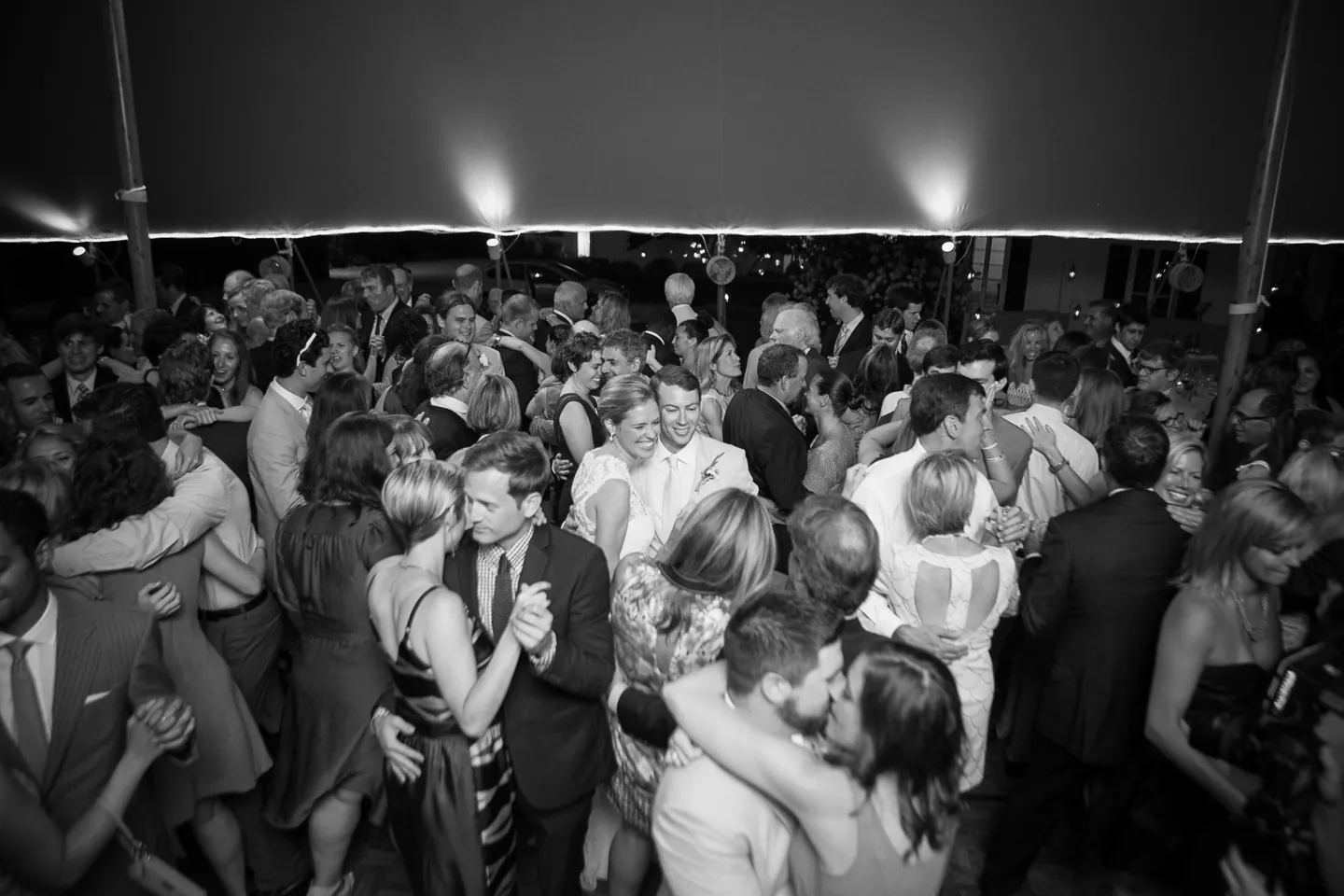 Black and white frame of a packed dance floor under the tent