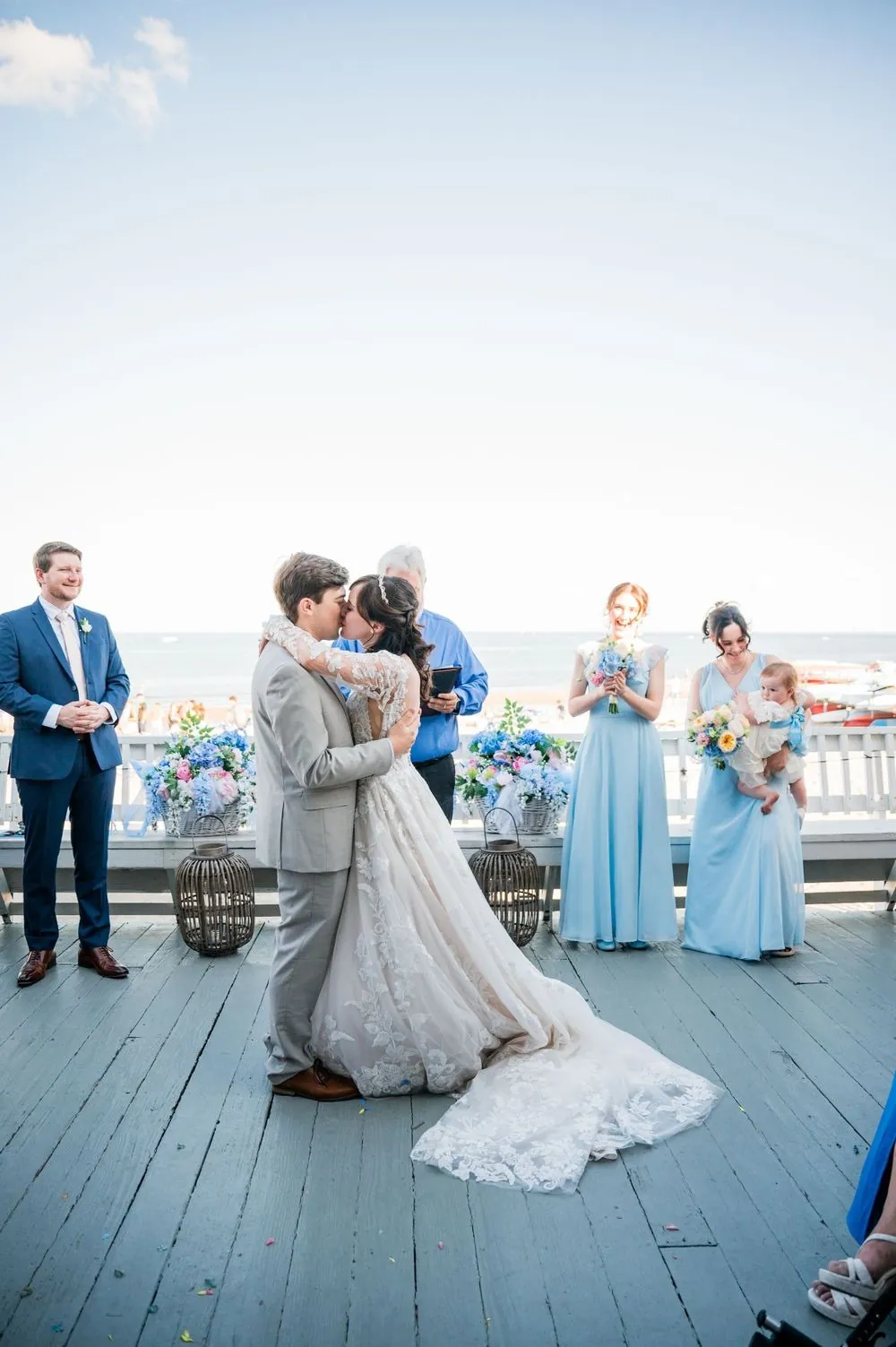 Bride walks toward the officiant on the pavilion deck, the Sound stretching out behind