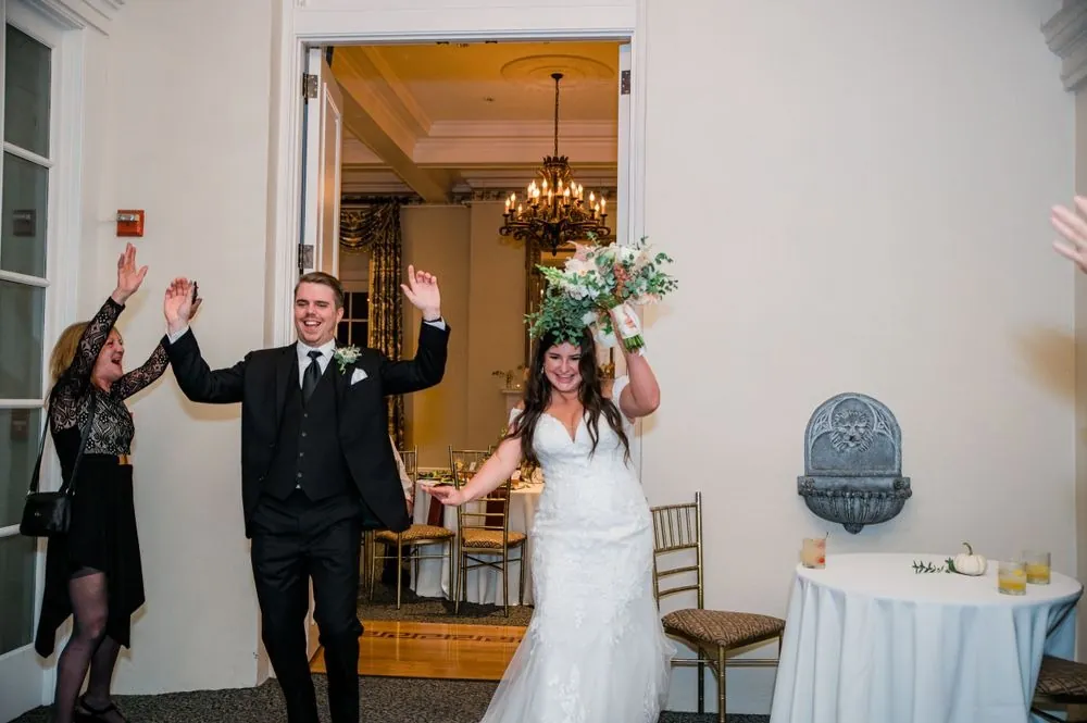 The couple makes their entrance into the reception with arms raised