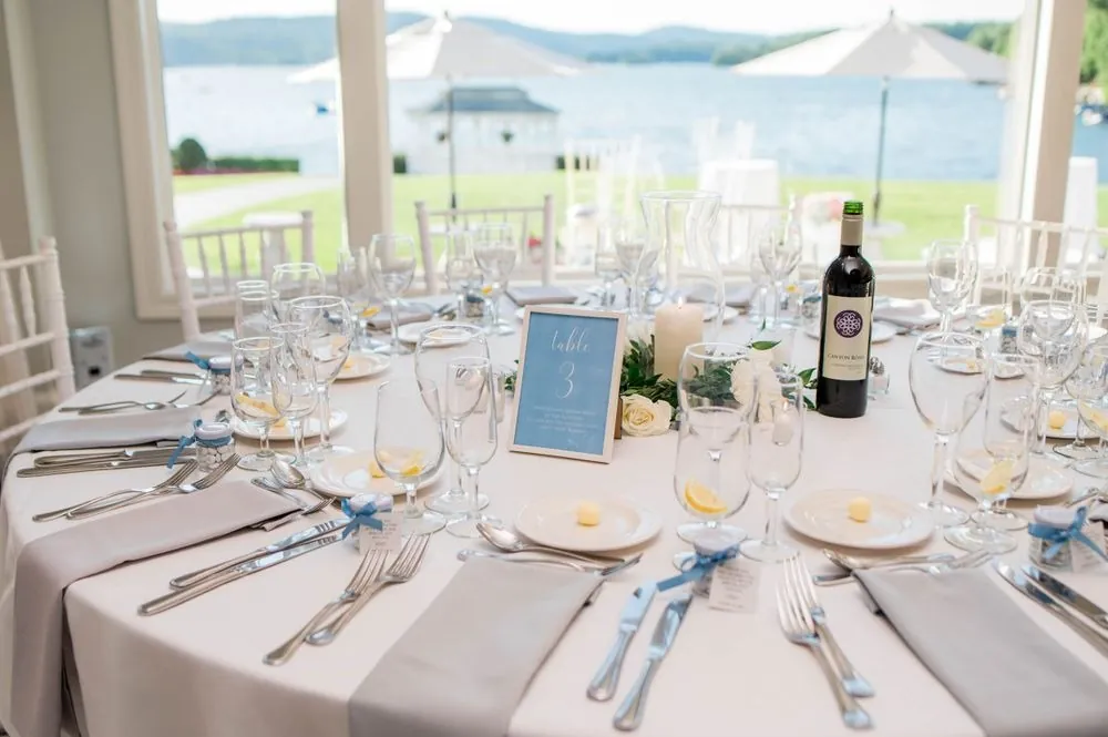 Reception table in soft blue and silver with Candlewood Lake beyond the windows