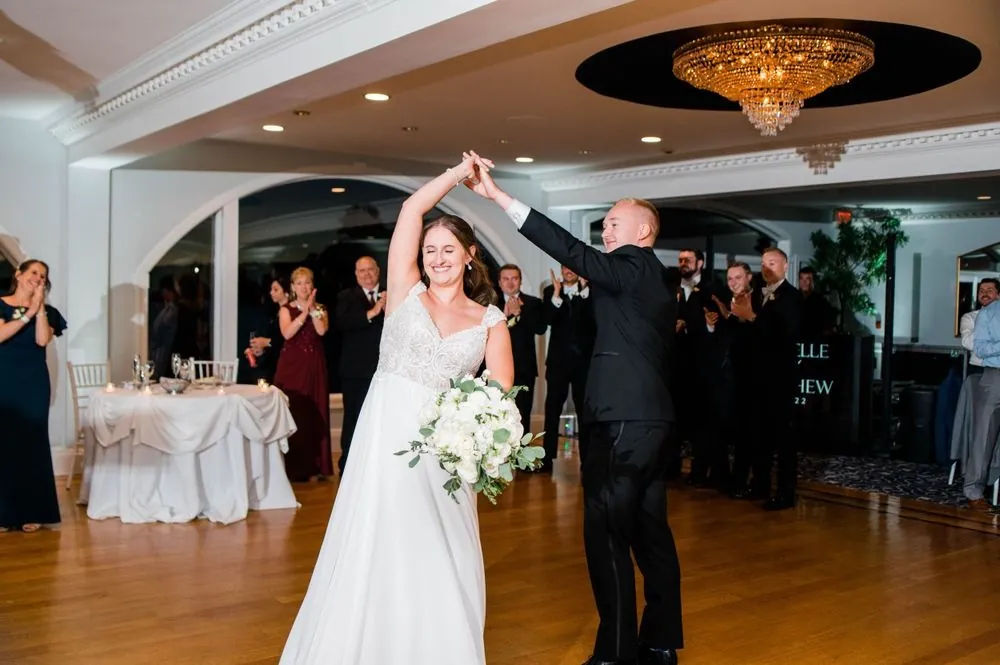 Matt spins Michelle during the first dance as guests watch from their tables