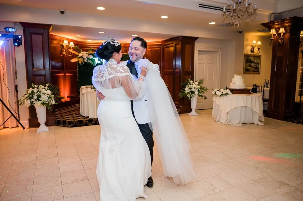 The couple shares a first dance in the reception room as her cape swings out