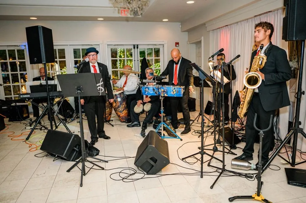 A live salsa band with horns, keys and congas plays in the reception room