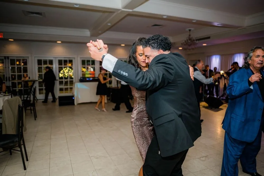 Guests dance salsa across the floor as the band plays