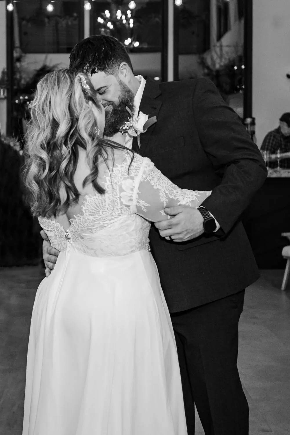 Black and white of the bride's lace back during a close slow dance