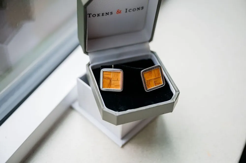 Square orange cufflinks in a small open gift box